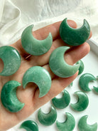 Closeup of Green Aventurine crescent moons shown on hand for scale, soothing crystals for love & abundance