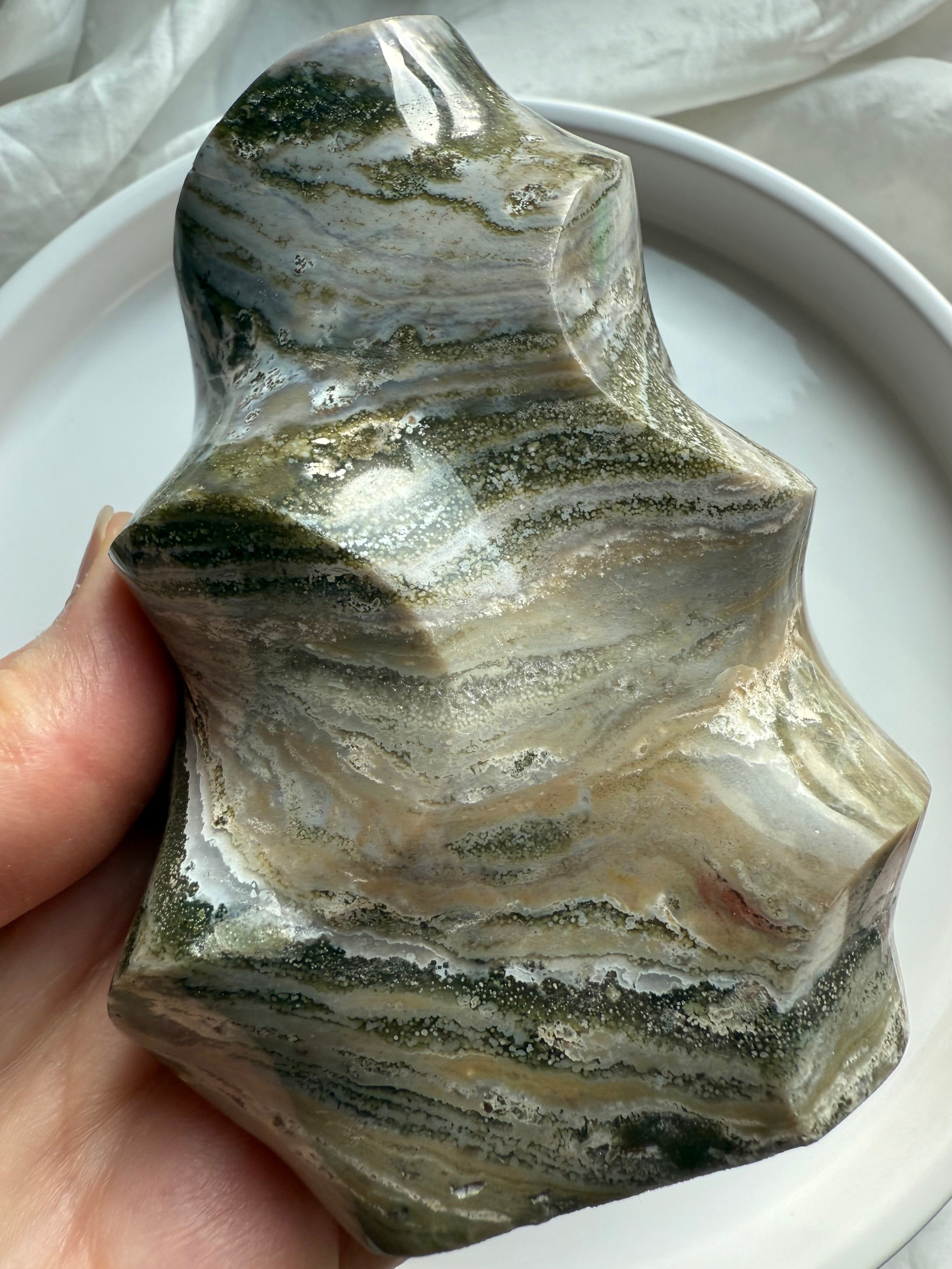 Green Ocean Jasper flame carving with swirling mossy bands and polished freeform shape, grounding Earth-energy crystal.