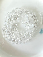 High clarity Clear Quartz bracelets displayed in hand with sparkling transparent crystal beads and polished finish