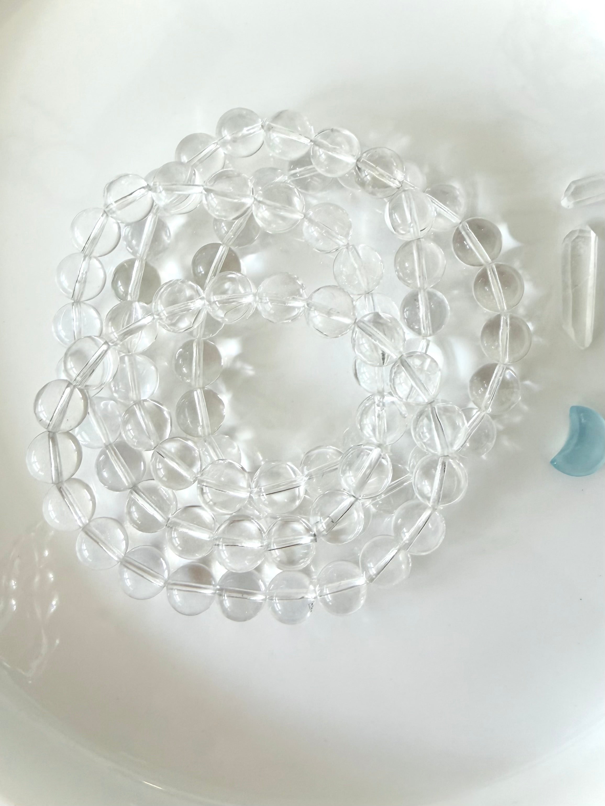High clarity Clear Quartz bracelets displayed in hand with sparkling transparent crystal beads and polished finish
