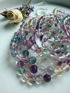 Mixed color fluorite bracelet coiled to highlight bead quality and smooth polished finish