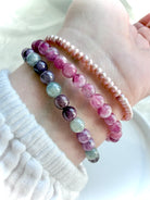 Pink Tourmaline bracelet layered with Ruby Sapphire and Pink Pearl bracelets, highlighting complementary crystal bracelet styling