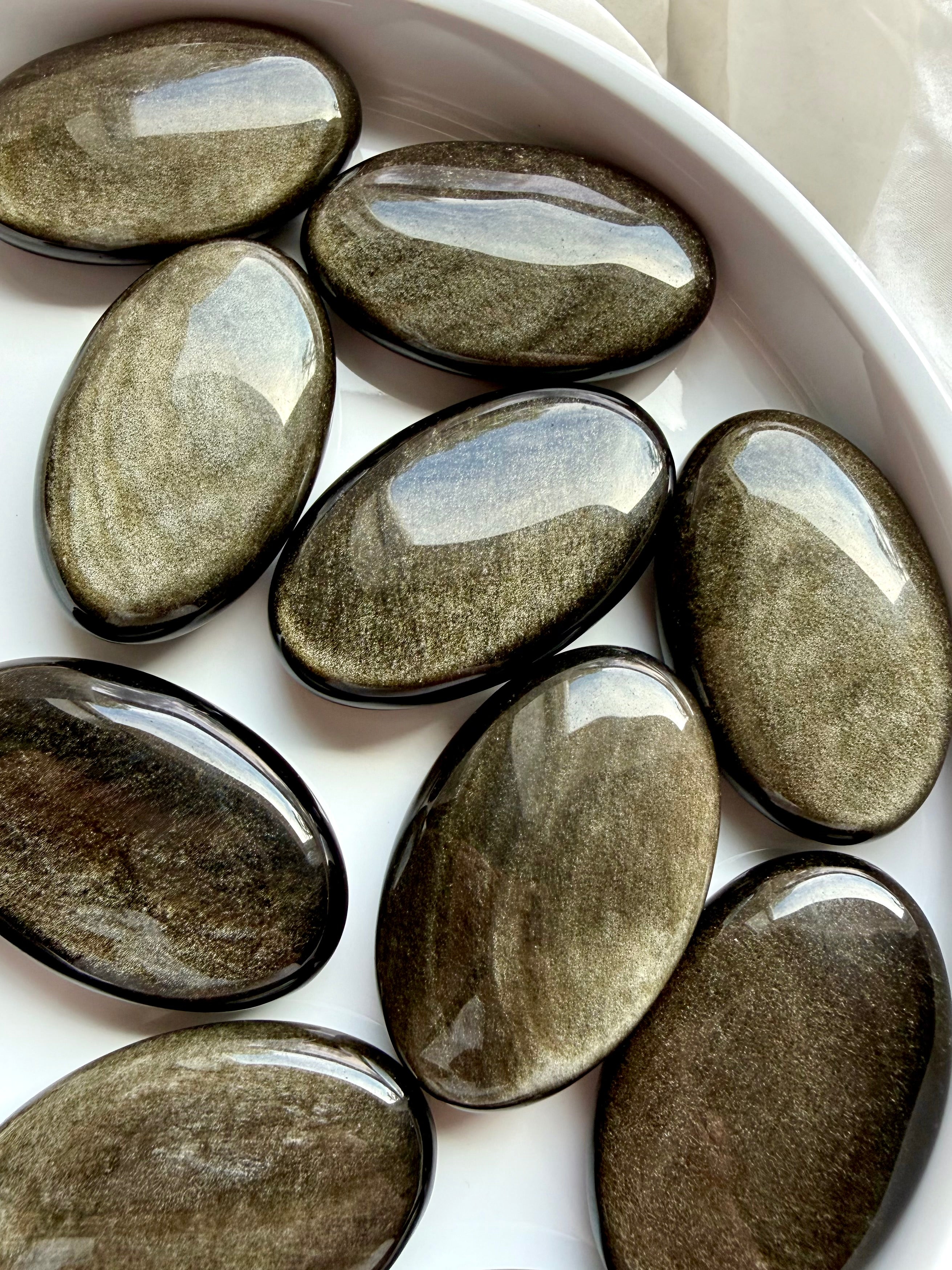 Polished Golden Sheen Obsidian palm stones showing shifting metallic shimmer for Solar Plexus Chakra and personal power
