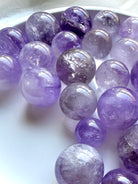 smoky amethyst crystal spheres assortment with pale lavender to deep purple tones