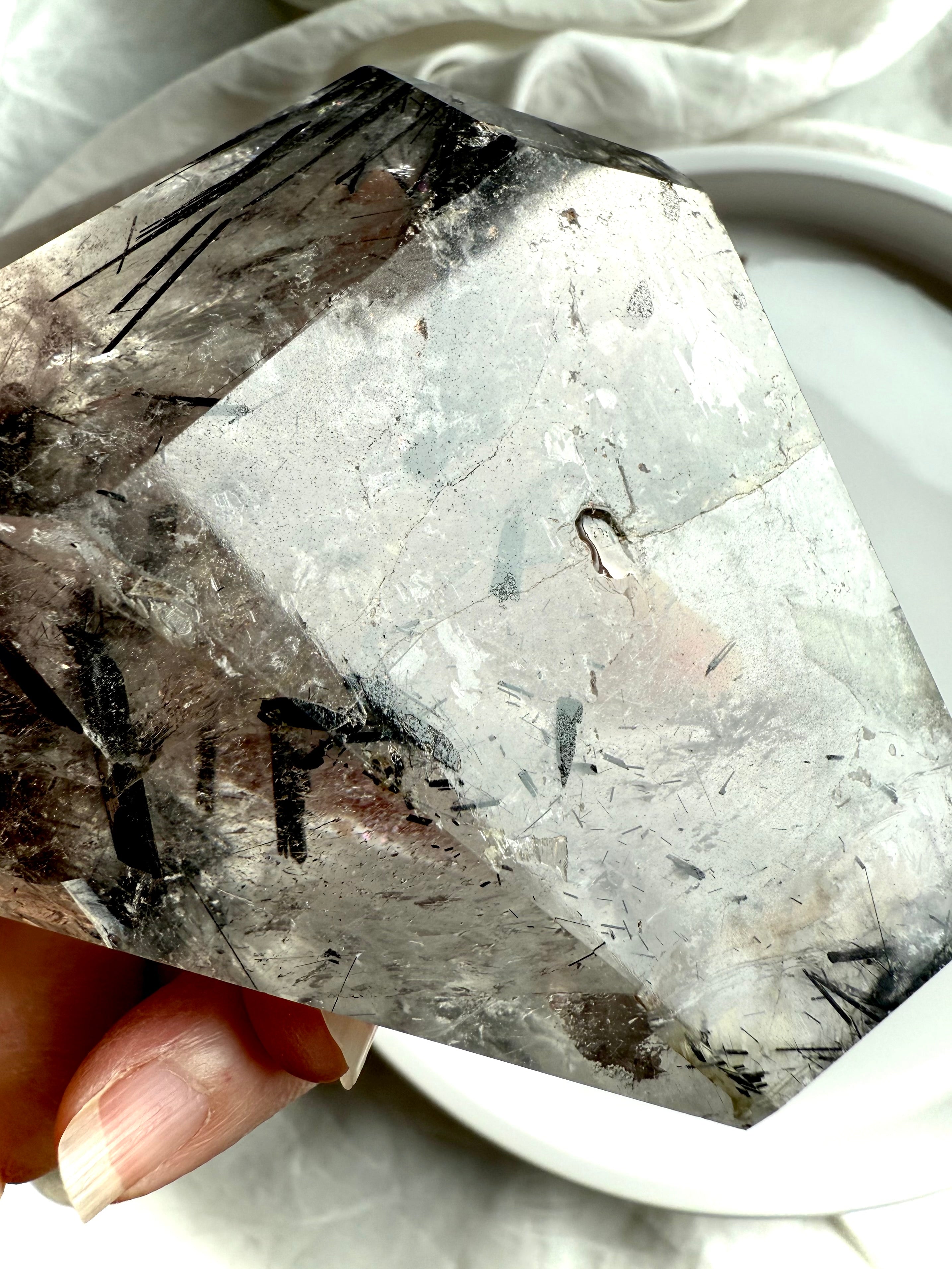 Detail view of Black Tourmaline in Quartz freeform with a visible repair and natural crystal inclusions