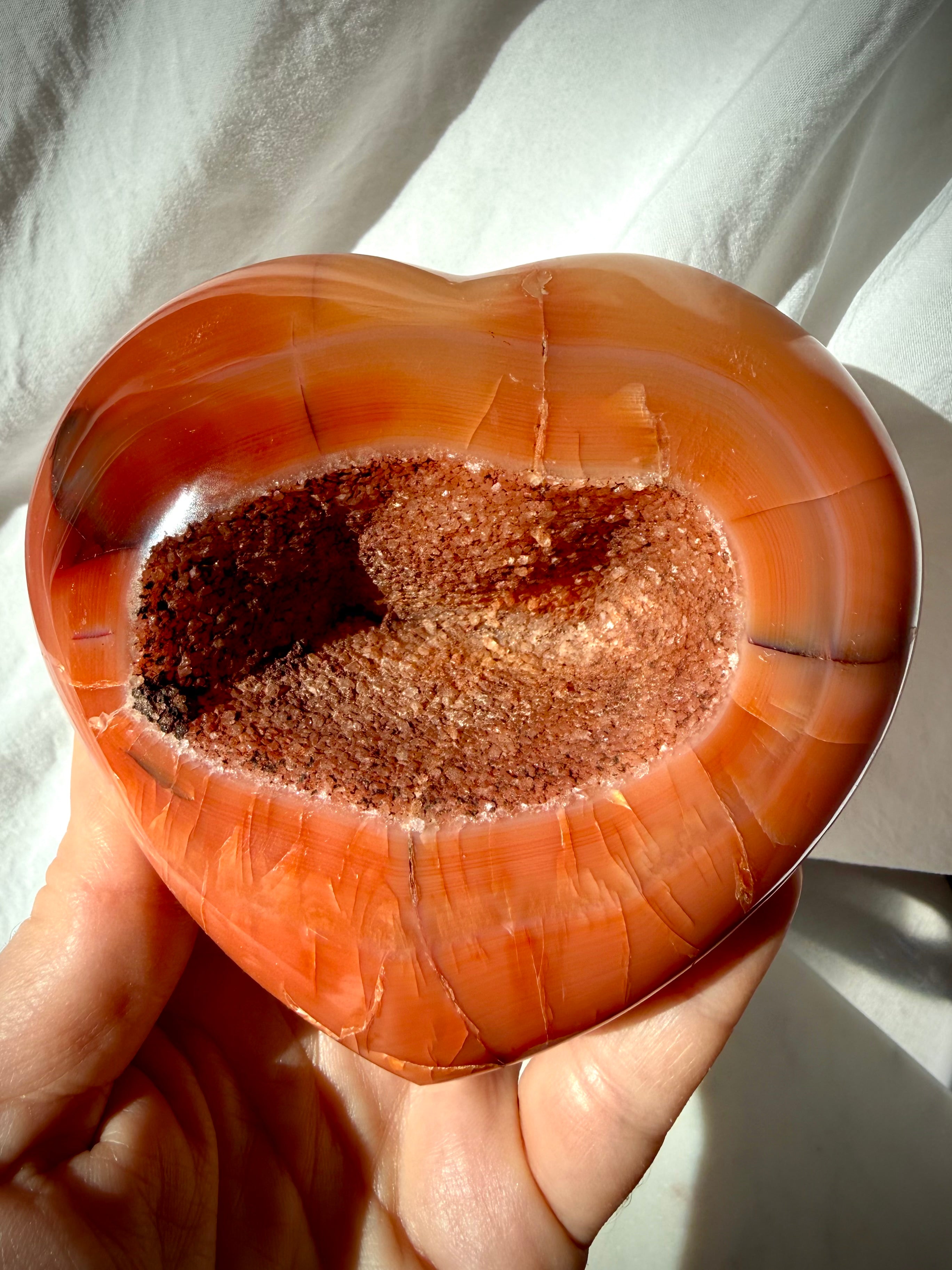 Large Carnelian geode heart crystal with sparkling druzy center and rich red-orange banding