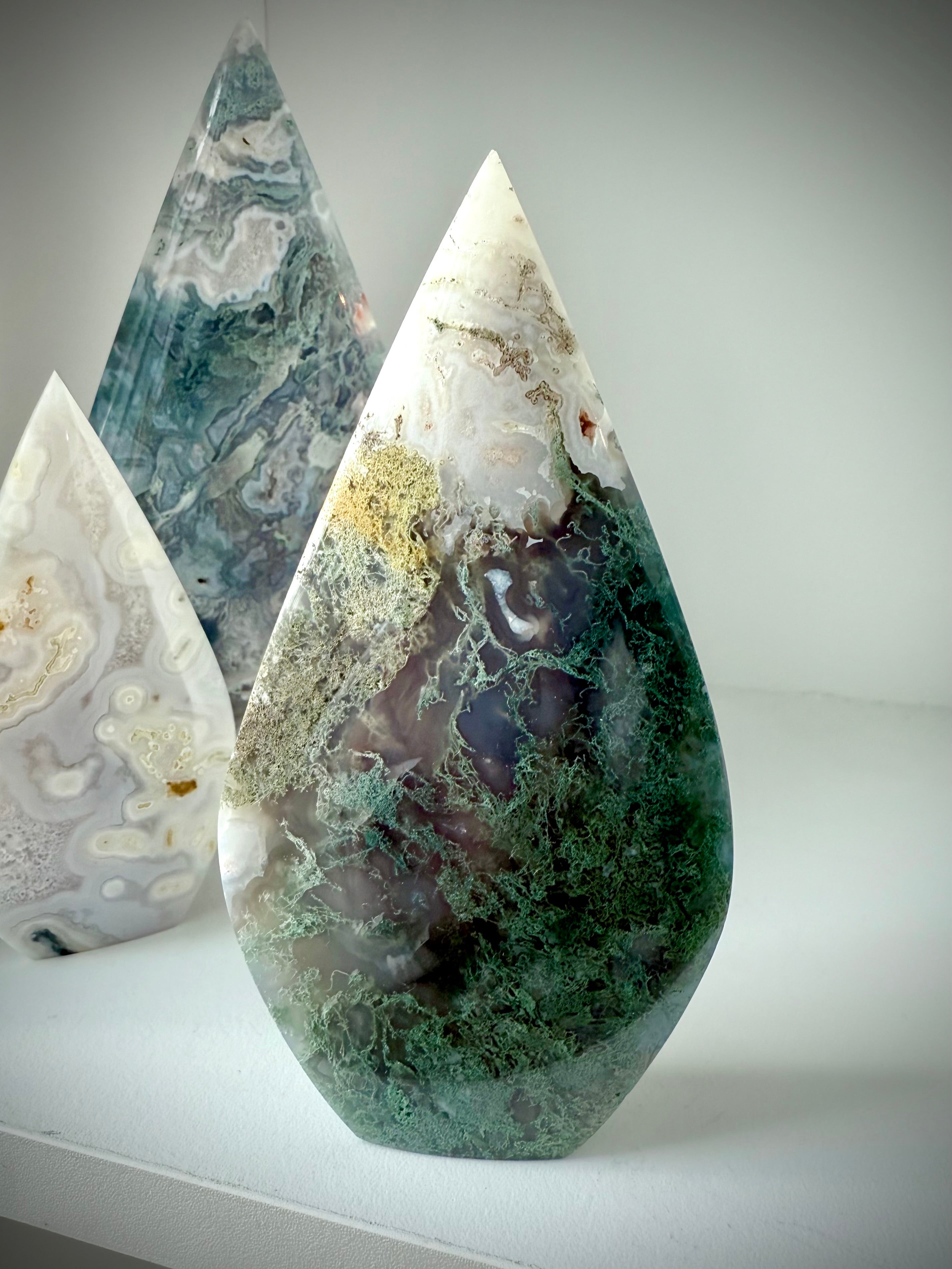 Self-standing Moss Agate flame crystal with ombré green coloration and moss-like inclusions, grounding altar display