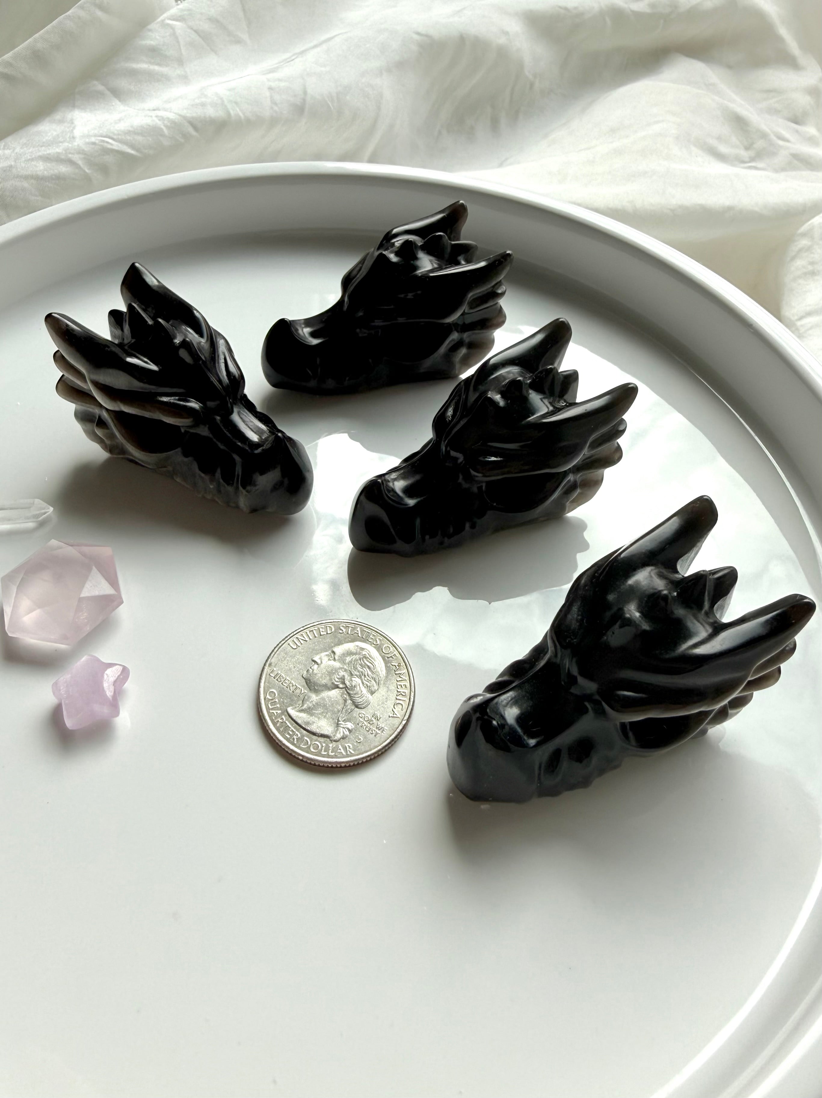 small silver sheen obsidian dragon carvings styled with a US quarter for scale, protective crystals for grounding and psychic protection