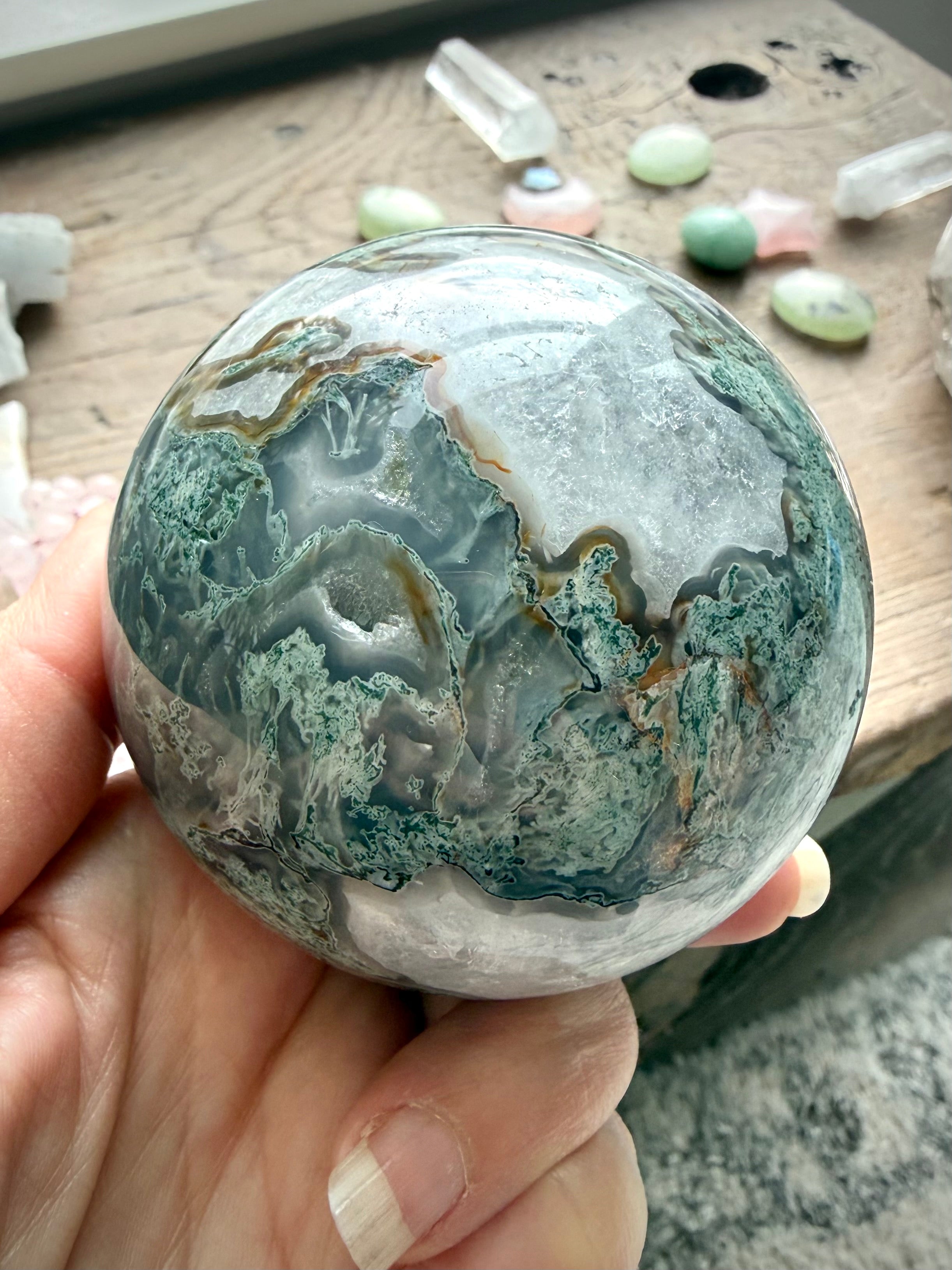 Moss Agate sphere close up showing Quartz veining, translucent areas, and unique mineral patterns