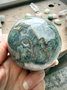 Moss Agate sphere close up showing Quartz veining, translucent areas, and unique mineral patterns