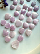 Angled view of Pink Kunzite crystal hearts on white — soothing heart chakra stones for emotional support & spiritual healing.