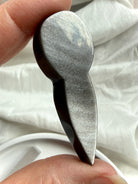 Silver Sheen Obsidian goddess carving showing flat polished back and natural silvery sheen