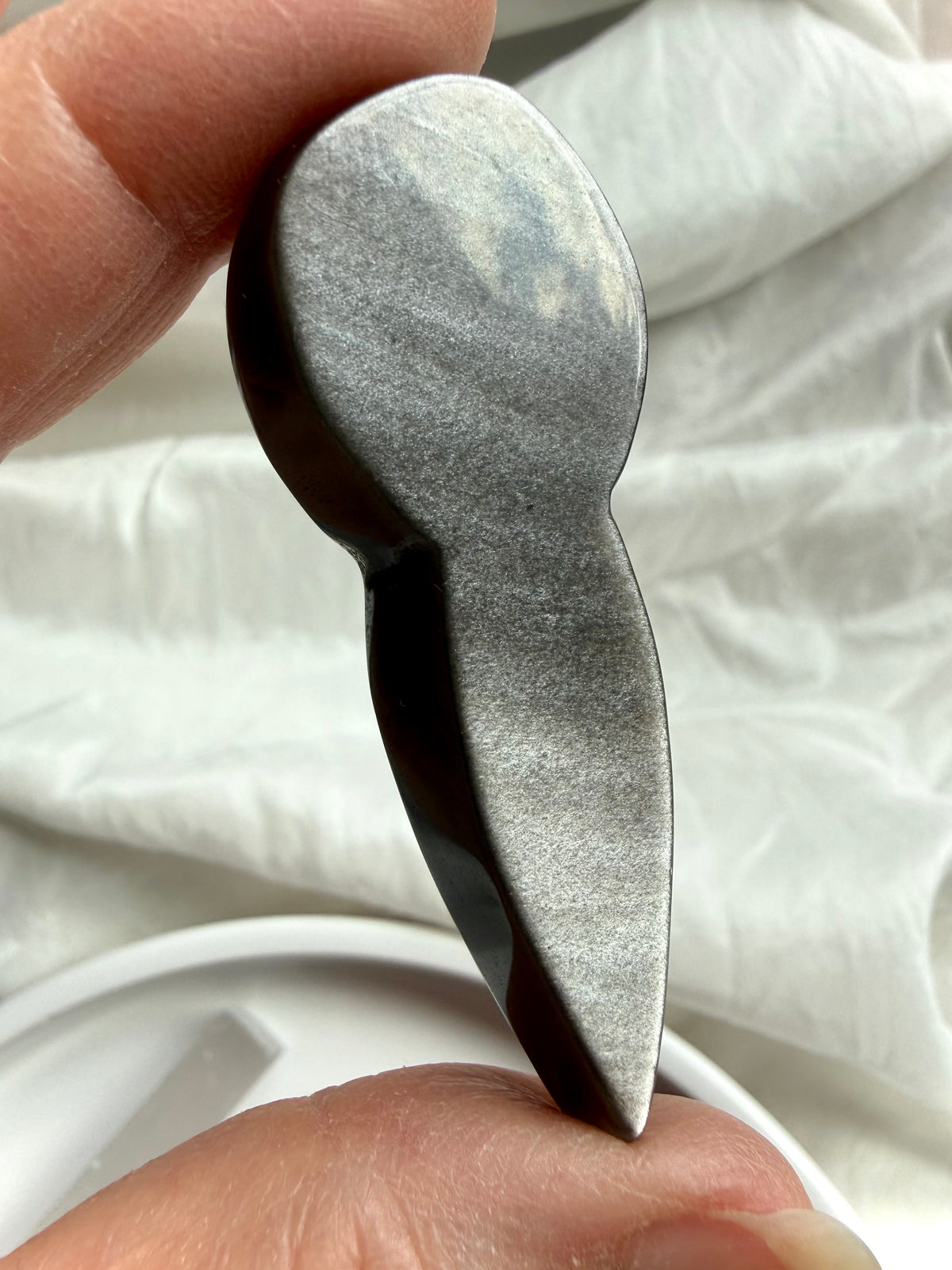Silver Sheen Obsidian goddess carving showing flat polished back and natural silvery sheen