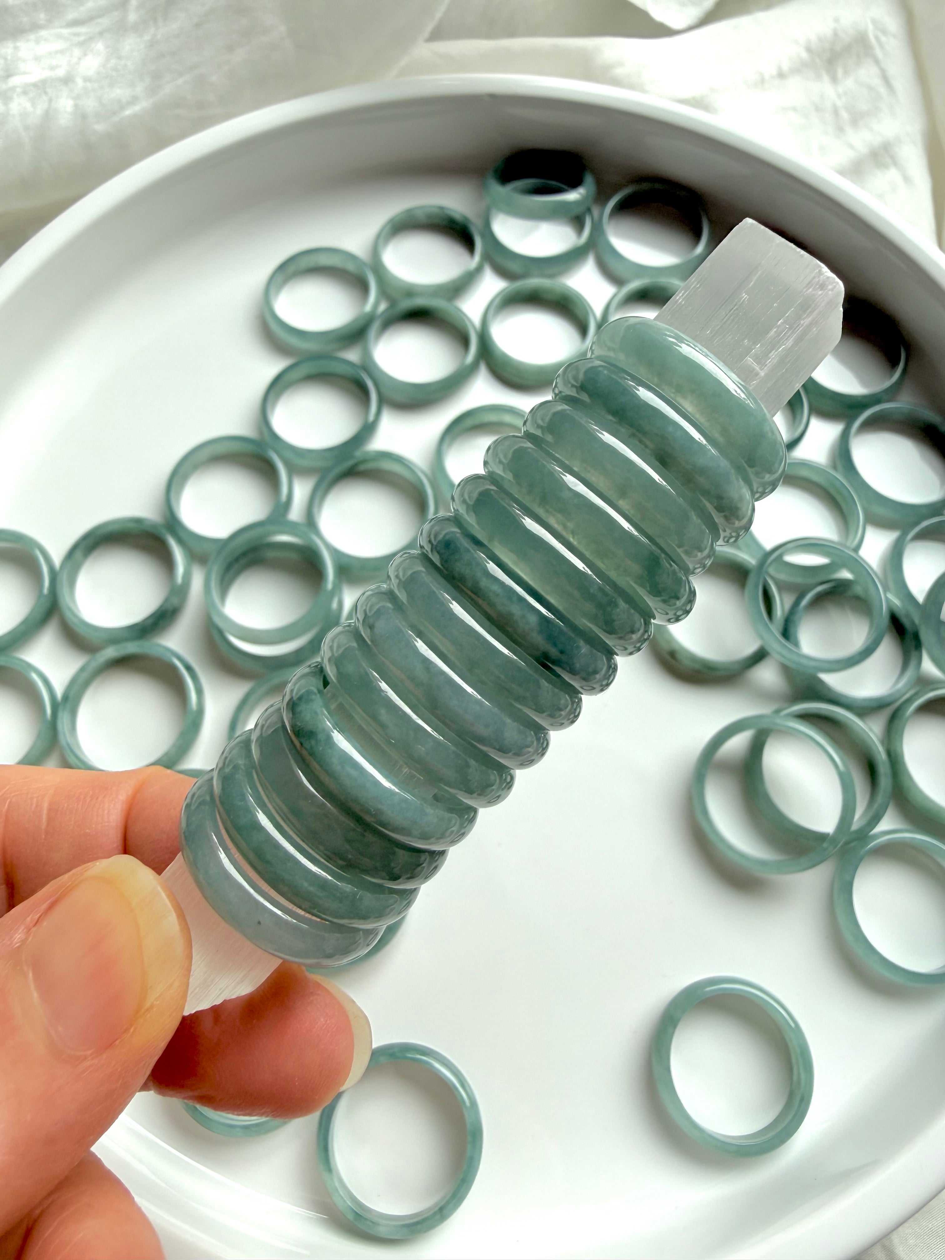 Stack of rounded Blue Water jade rings showing smooth polished jadeite bands