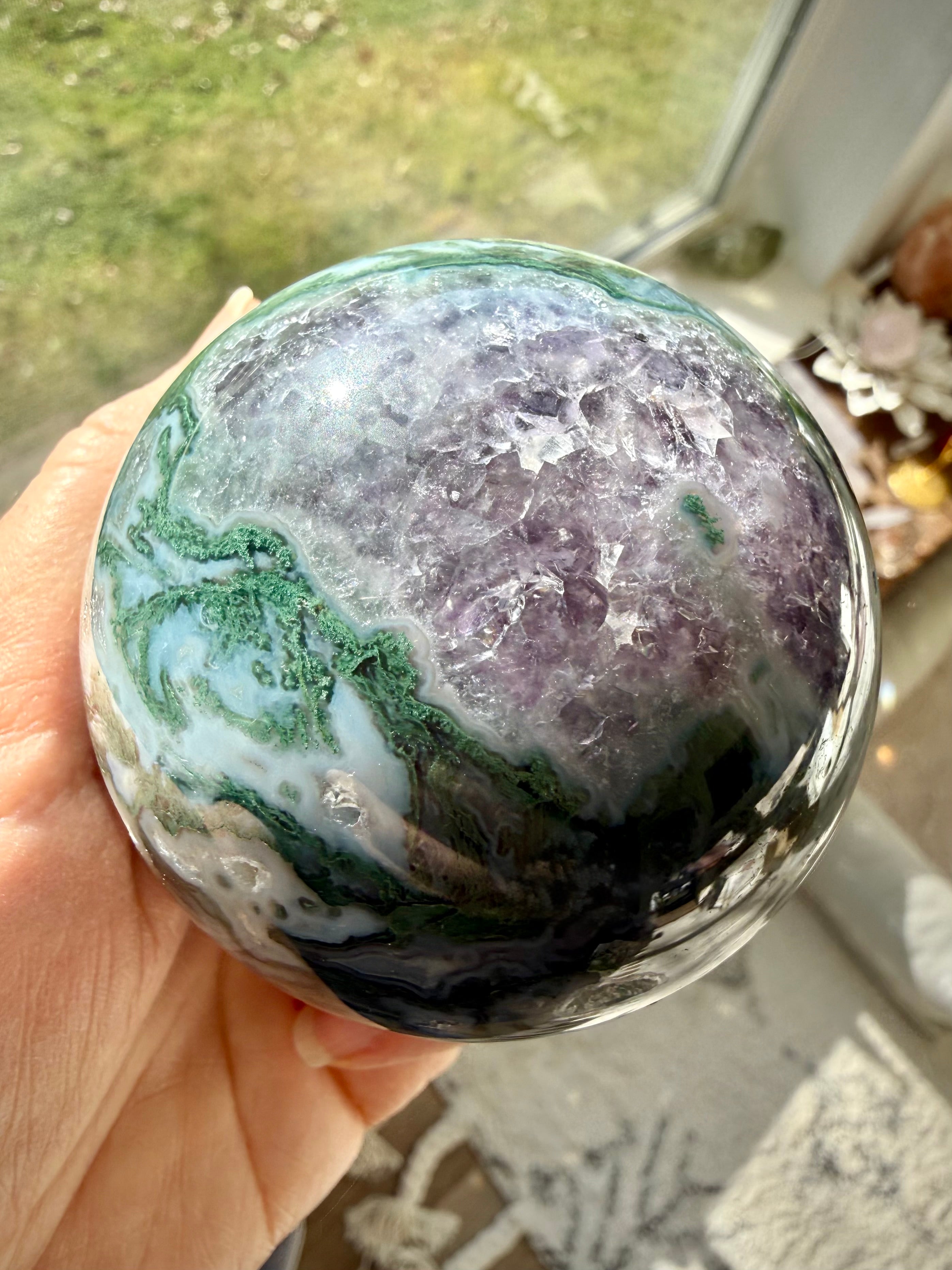 Moss Agate Amethyst sphere close up showing natural crystal patterns, druzy texture, and polished finish