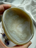 Beige agate crystal bowl with translucent layers and natural texture – grounding gemstone décor piece
