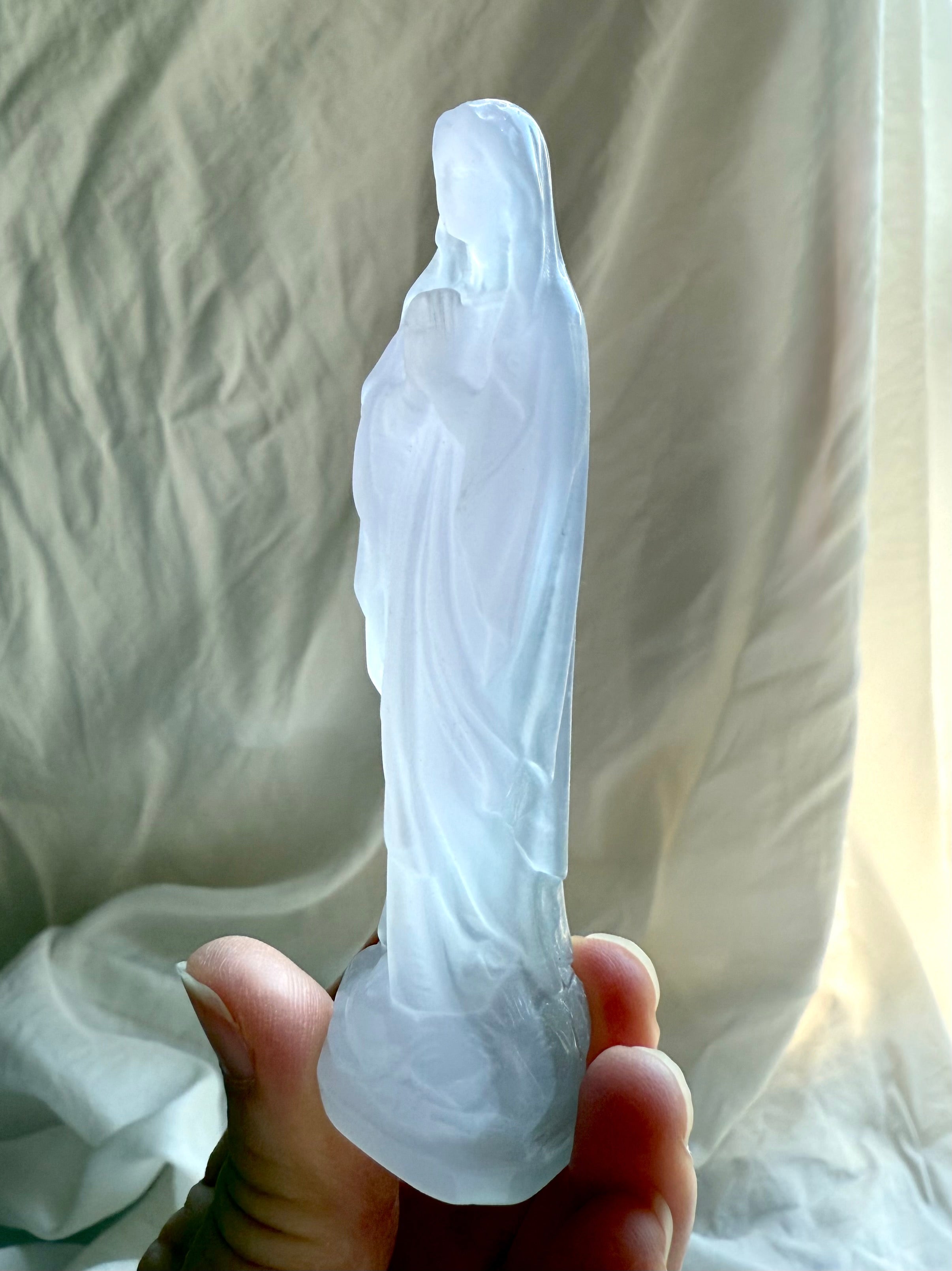 Lavender Fluorite Mother Mary figurine showing the serene prayer pose and softly translucent pastel crystal