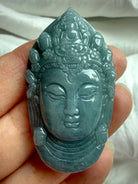 Blue Water Jade Guanyin pendant carving close up with serene goddess face and detailed crown