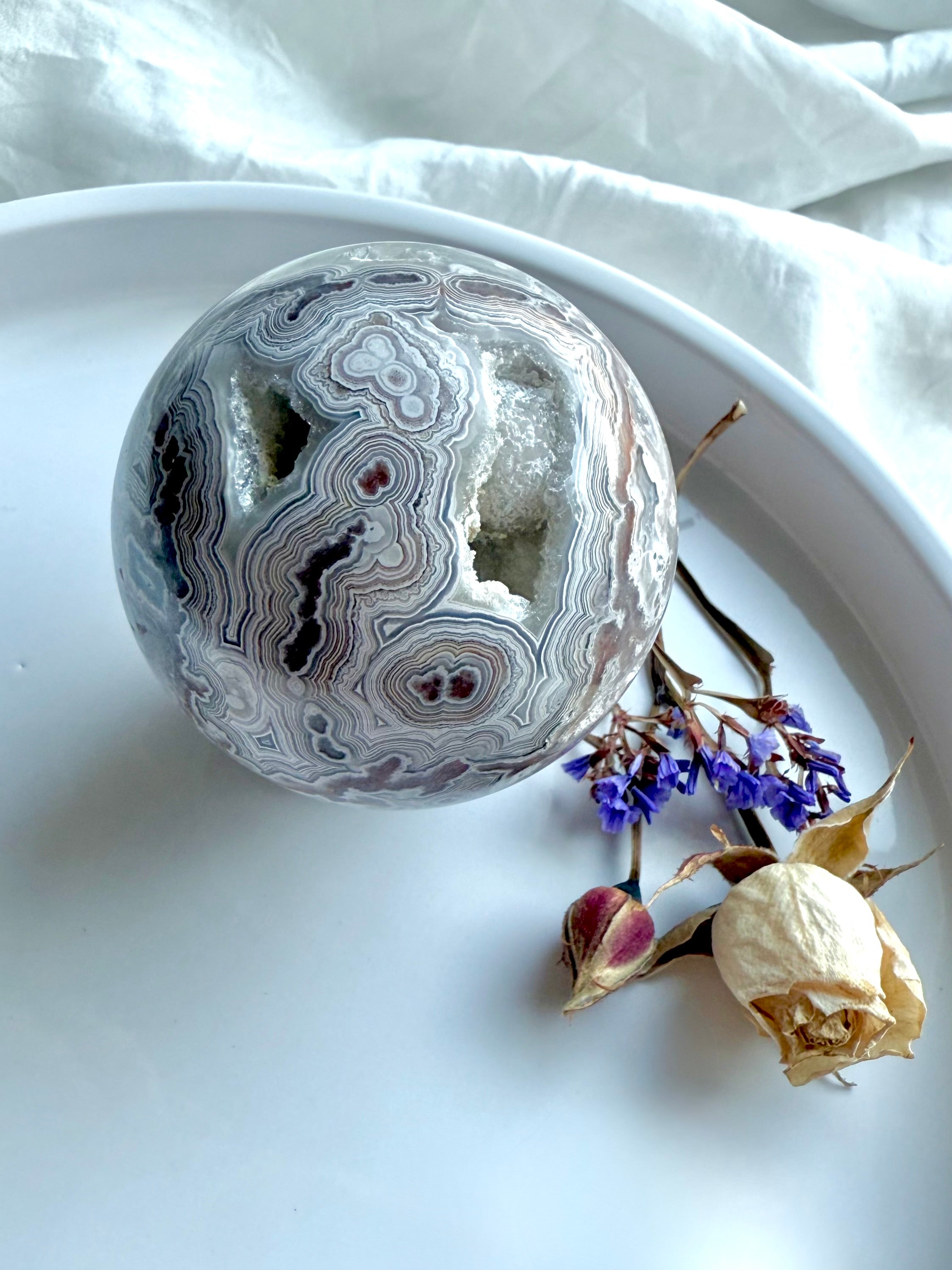 Crazy Lace Agate crystal sphere with pink quartz druzy, striking lace formations, and layered swirls of red and white