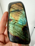 Labradorite freeform reverse view showing subtle green, gold, aqua, and copper labradorescence and natural patterning
