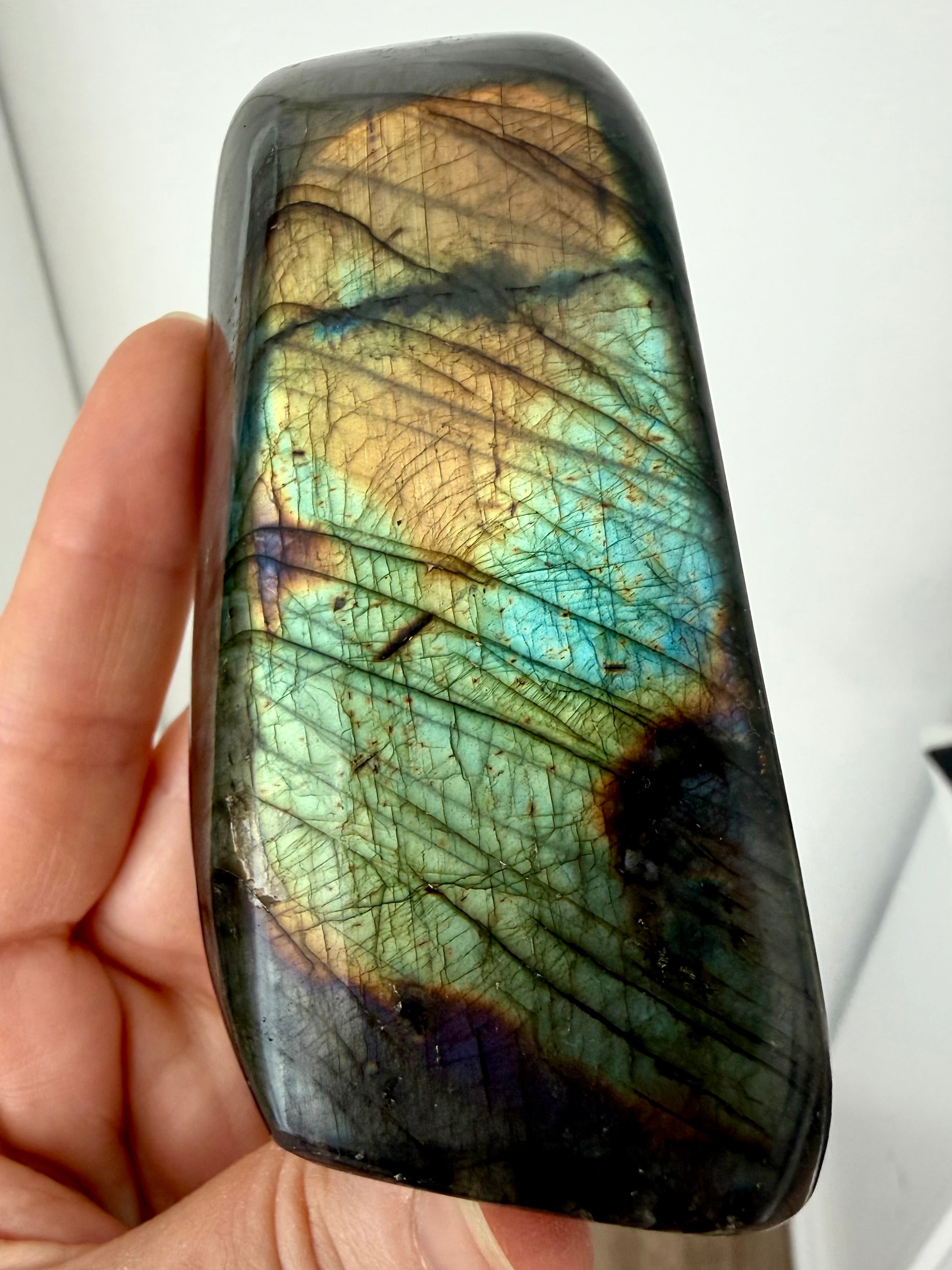 Labradorite freeform reverse view showing subtle green, gold, aqua, and copper labradorescence and natural patterning
