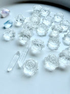 Mini Clear Quartz lotus flower carvings arranged together, small healing crystals for meditation and intention setting