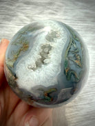 Moss Agate geode sphere with sparkling Quartz crystal cave, dendritic moss inclusions and blue-gray chalcedony banding