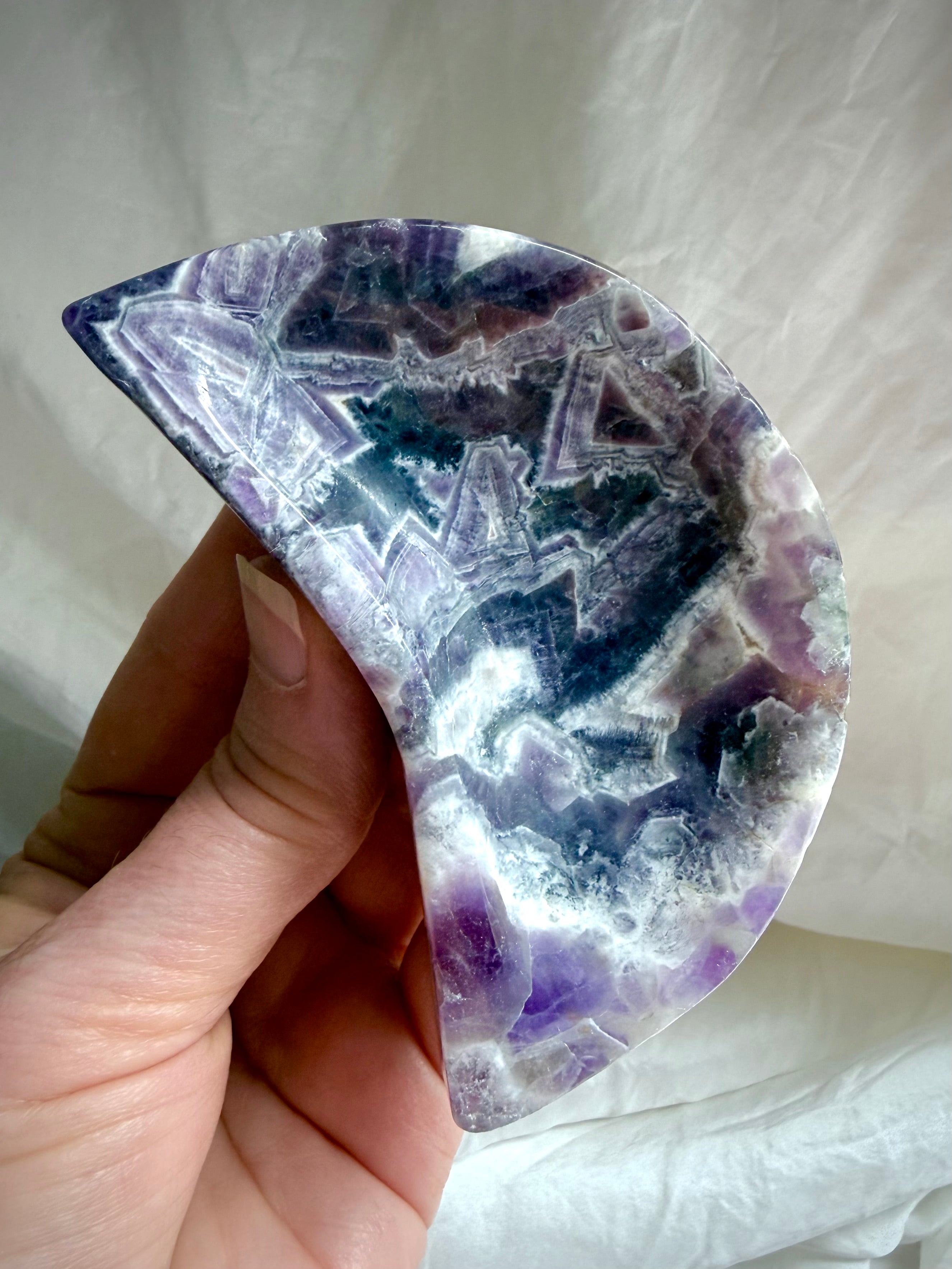 Handheld Dream Amethyst moon bowl showing size and polished finish, purple crystal crescent dish