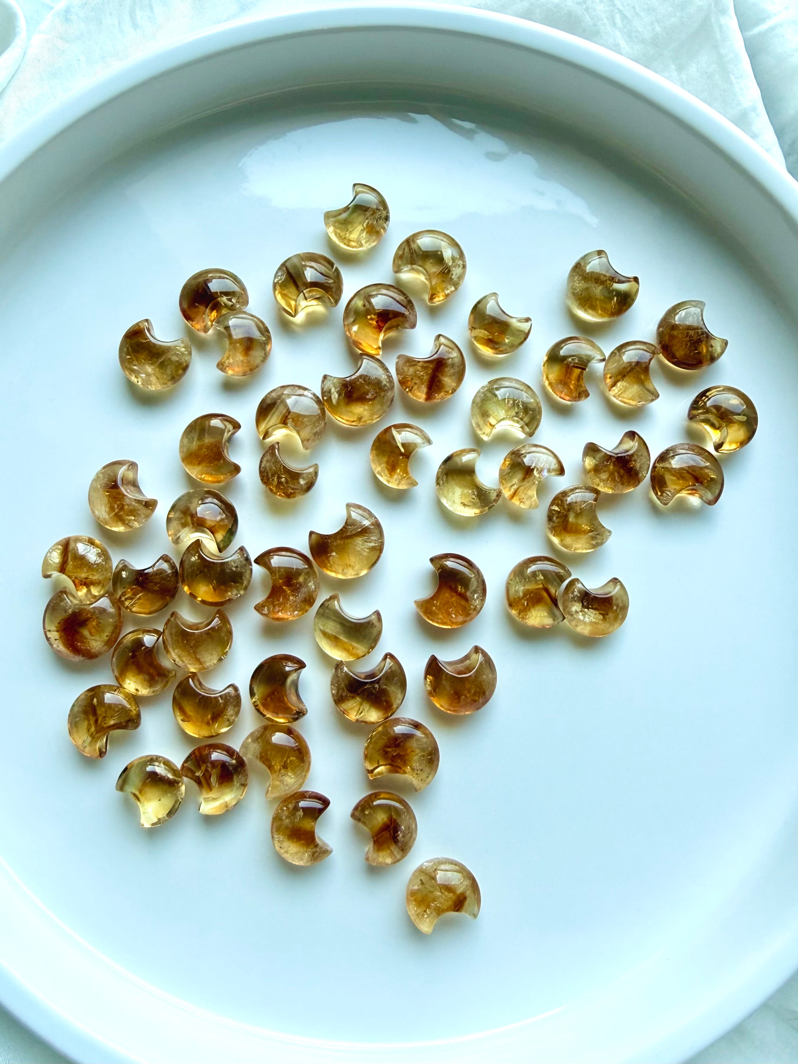 Mini Citrine moons showing natural variation in golden honey color, clarity, translucence and internal patterning