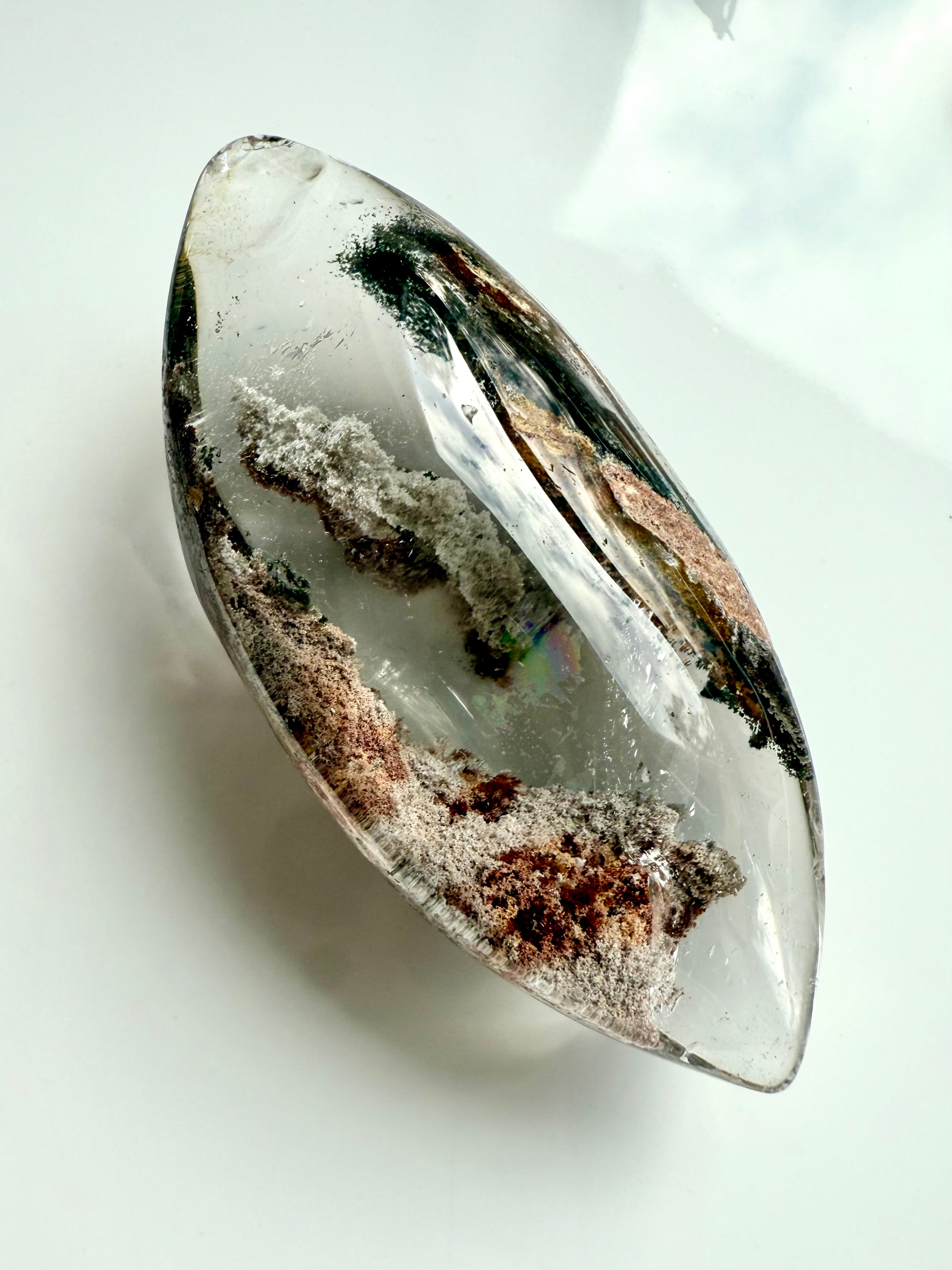 Garden Quartz marquise-shaped lens with phantom lines in earthy green, gold, rust tones, and a rainbow inclusion