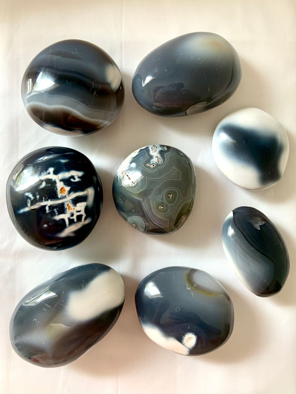 an array of beautiful orca agate palm stones with interesting black, white and gray patterns in the stones, choose your favorite!