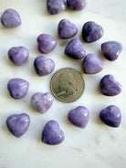 Mini Lepidolite heart crystals with a quarter for size comparison