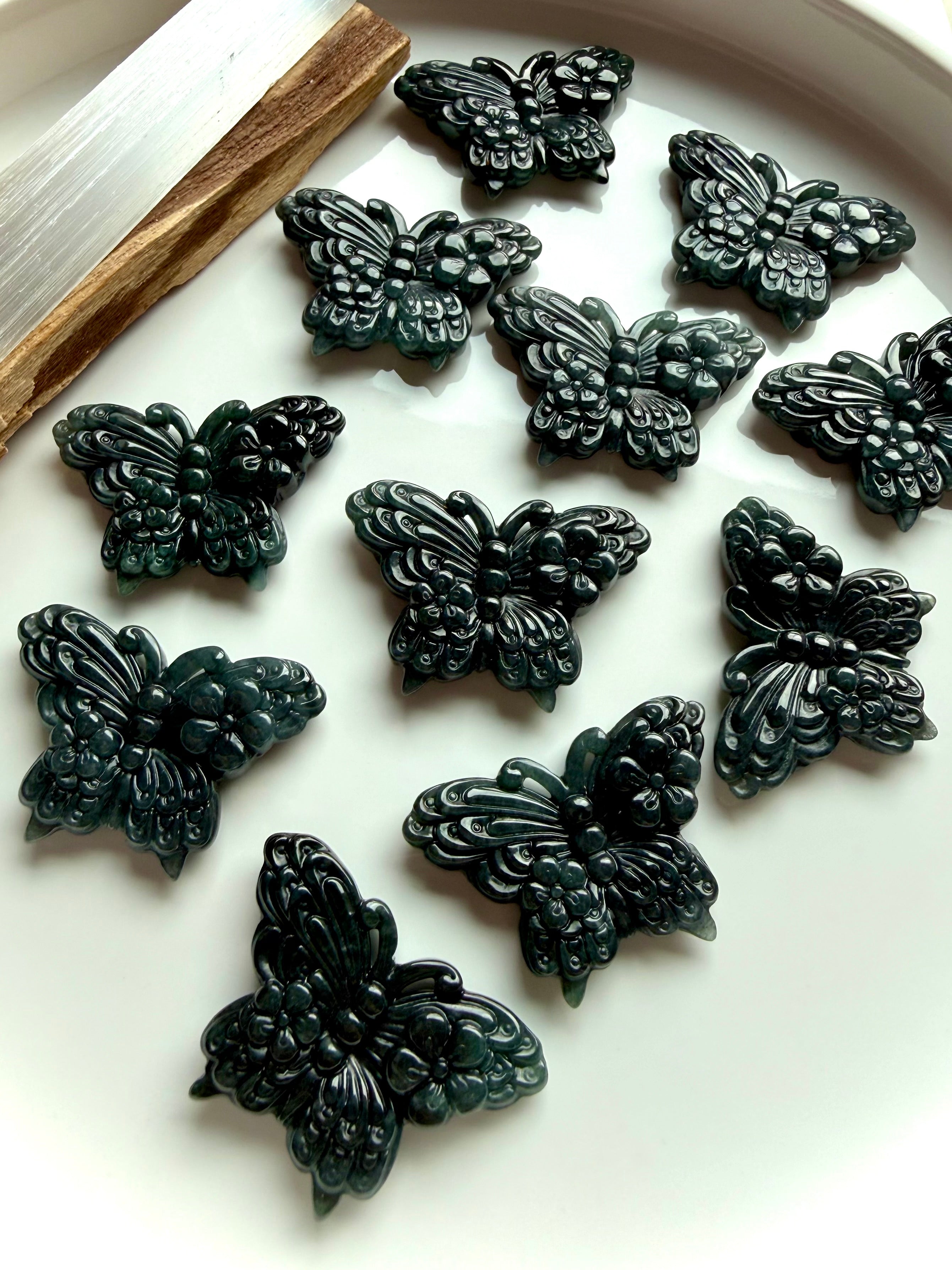 Wuji jade butterfly carvings in natural Guatemalan jade crystal showing deep green gemstone butterfly carvings