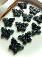 Wuji jade butterfly carvings in natural Guatemalan jade crystal showing deep green gemstone butterfly carvings