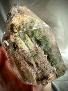 Thousand Layer Garden Quartz phantom crystal held in hand showing size, clarity, and layered chlorite inclusions