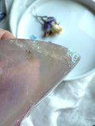 Aura Rose Quartz moon bowl with soft lavender hues and angelic iridescence, close up detail showing the imperfections 