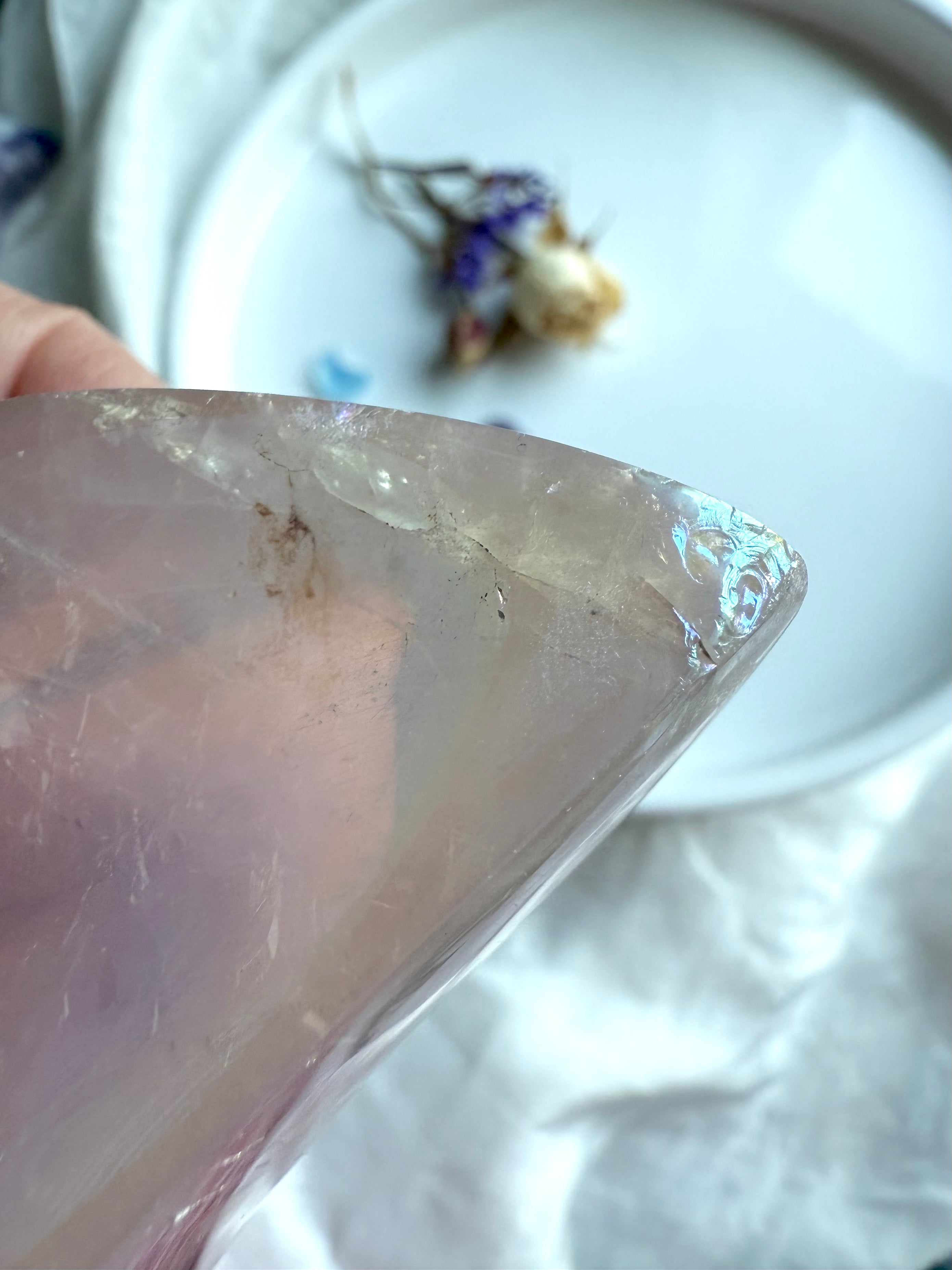 Aura Rose Quartz moon bowl with soft lavender hues and angelic iridescence, close up detail showing the imperfections 