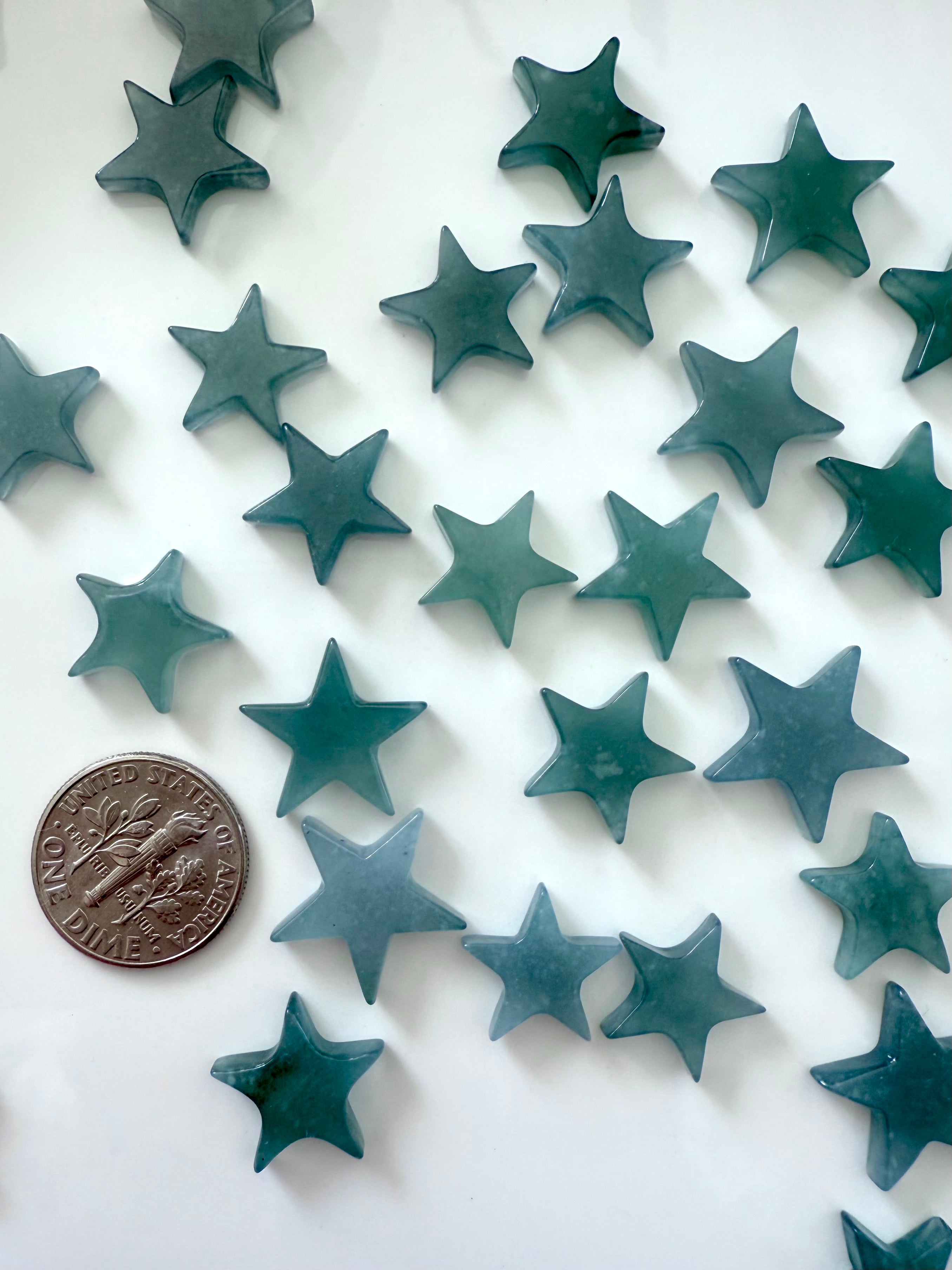 Mini Blue Water Jade Stars shown with a quarter for scale