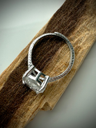 side view of sterling silver moon ring showing details of adjustable band design on wooden surface