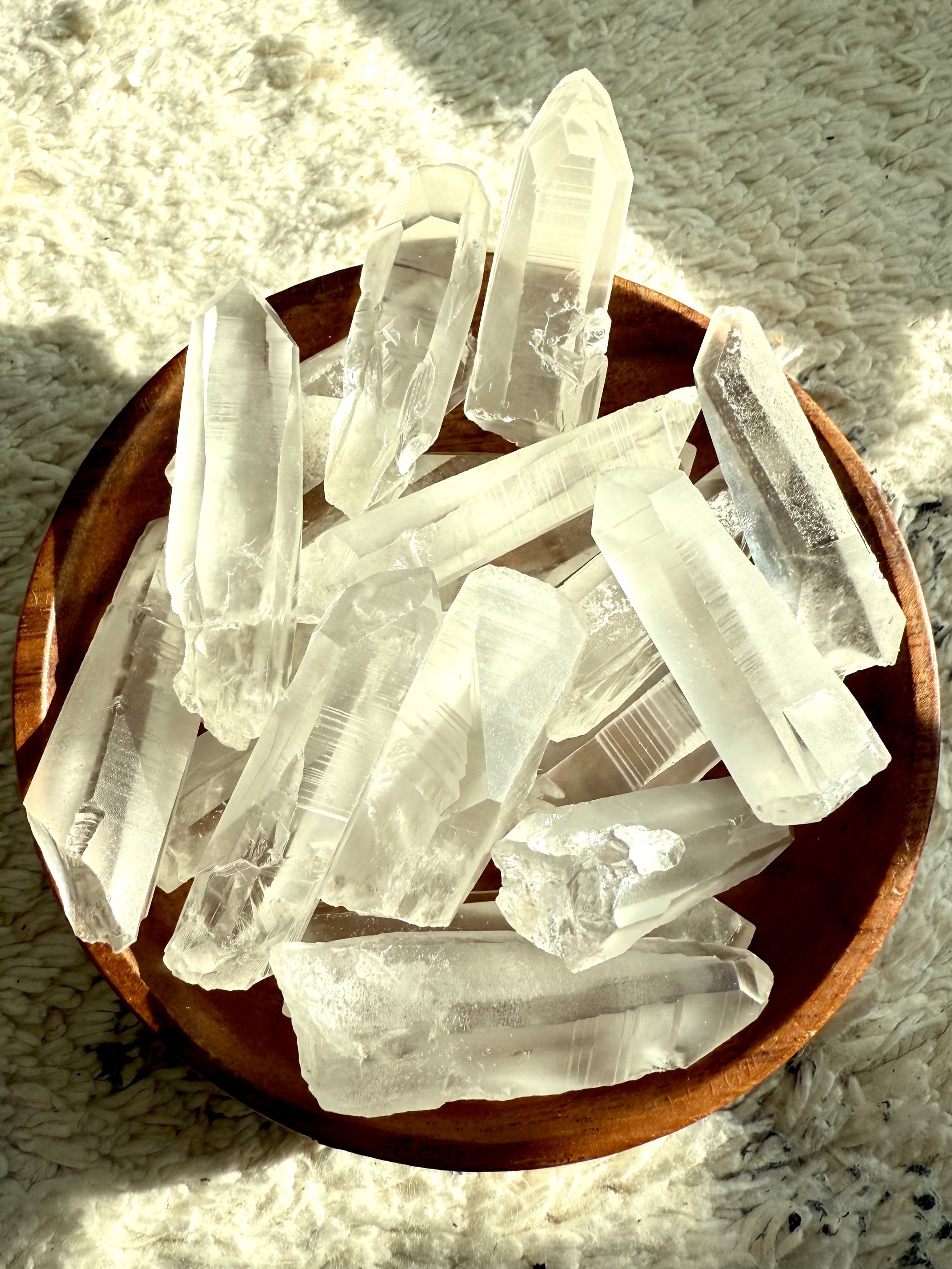 Assorted Lemurian Quartz Points in a wooden bowl — authentic Brazilian crystals for spiritual connection, aura cleansing & meditation.