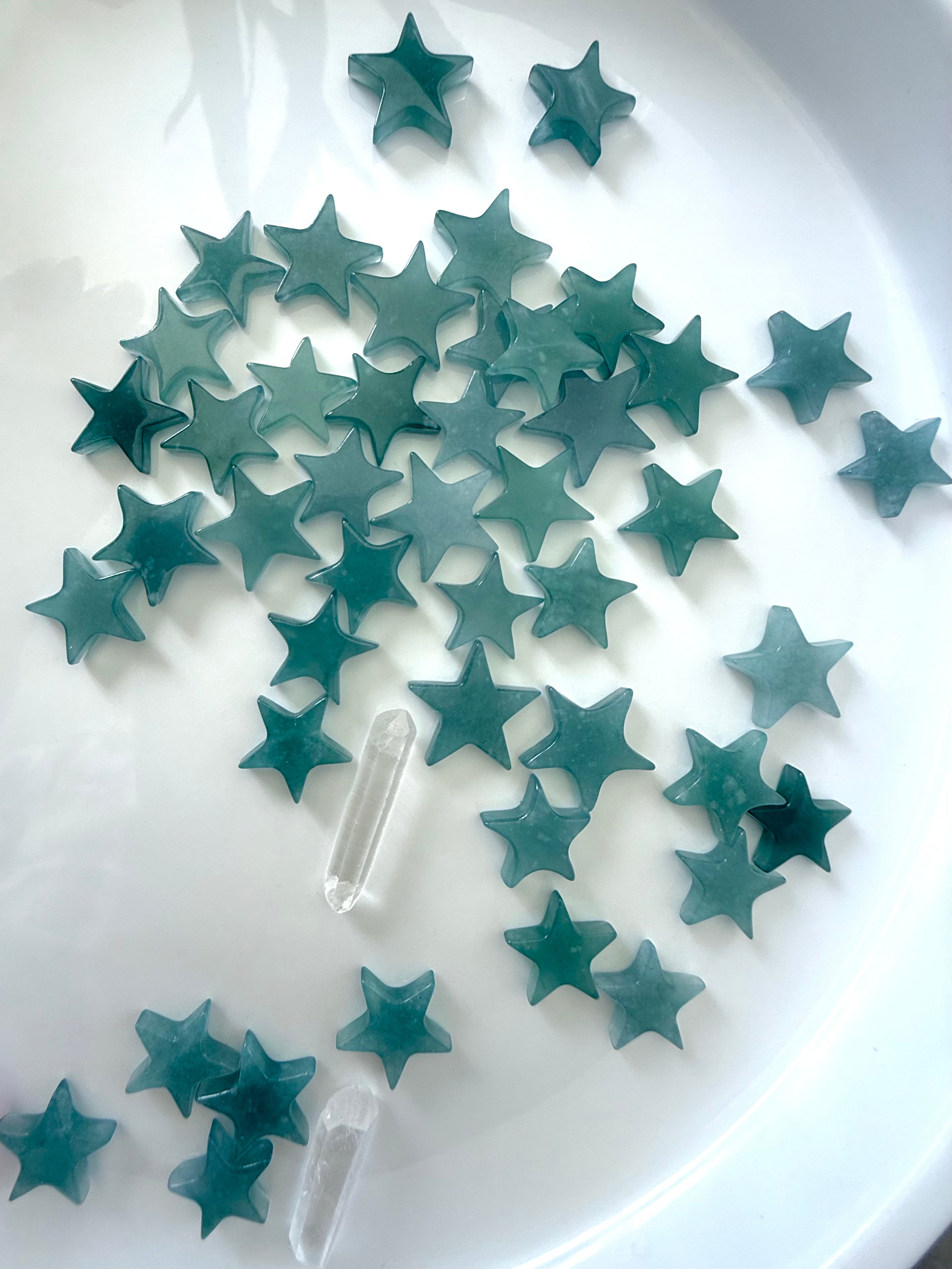 Blue Water Jadeite Stars photographed on a white plate in natural ambient light