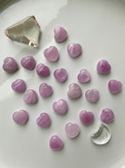 Wide shot of Pink Kunzite mini hearts with other crystals on a white background — soft pink crystal hearts for love, calm & intentional energy work.