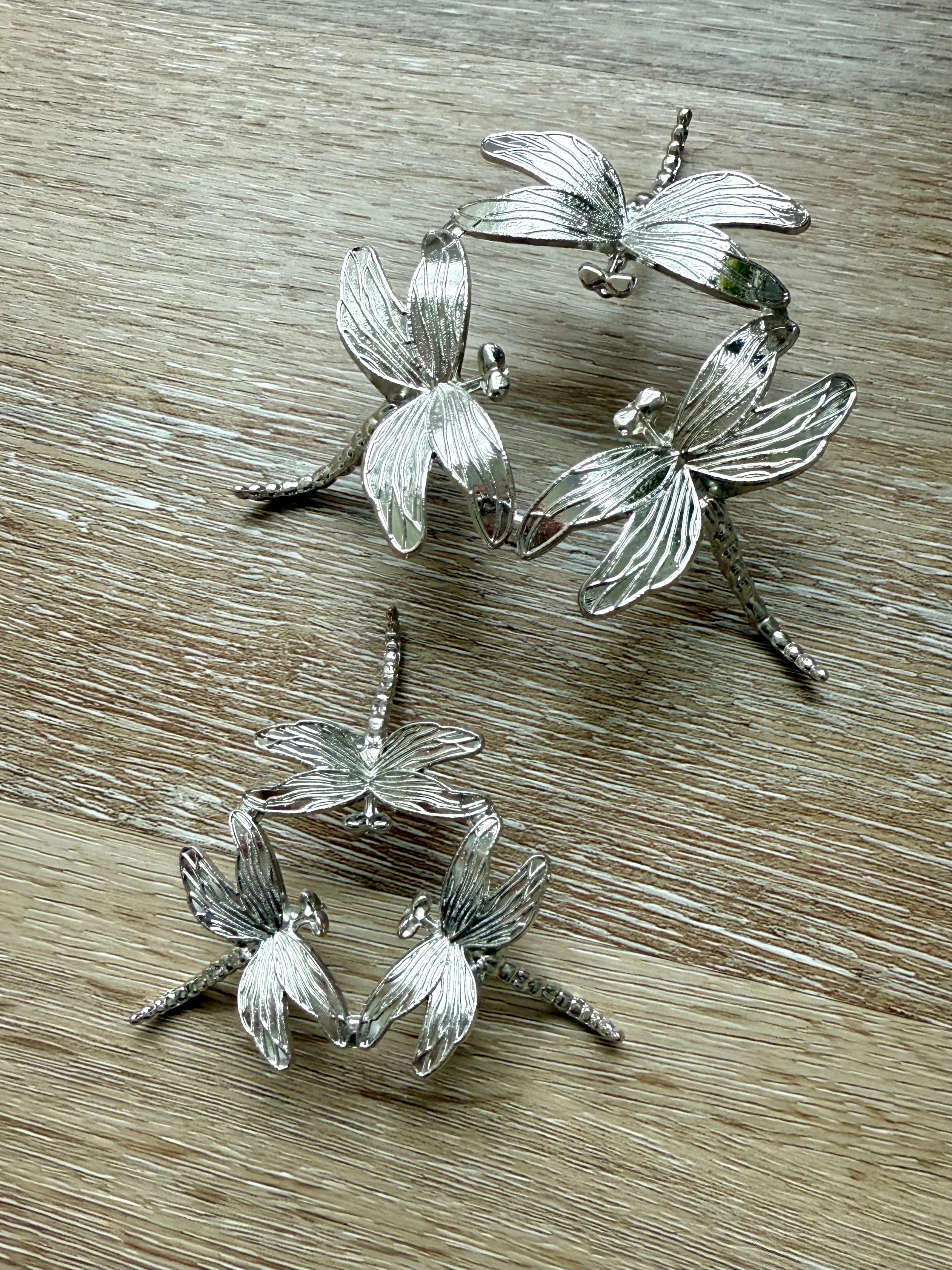 Our Metal Dragonfly Crystal Sphere Stand shown with both size options side by side for comparison 