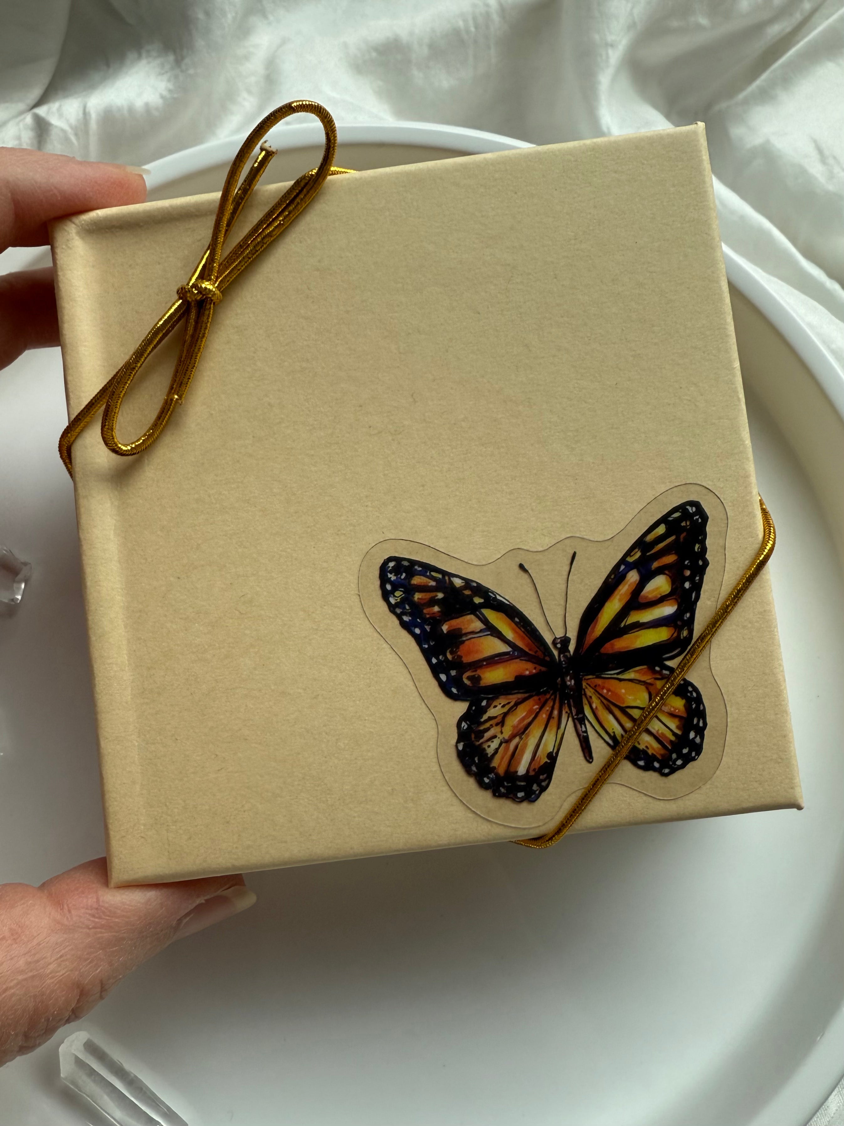 Butterfly gift box with gold cord packaging for Blue Chalcedony heart necklace, perfect for spiritual gifting.