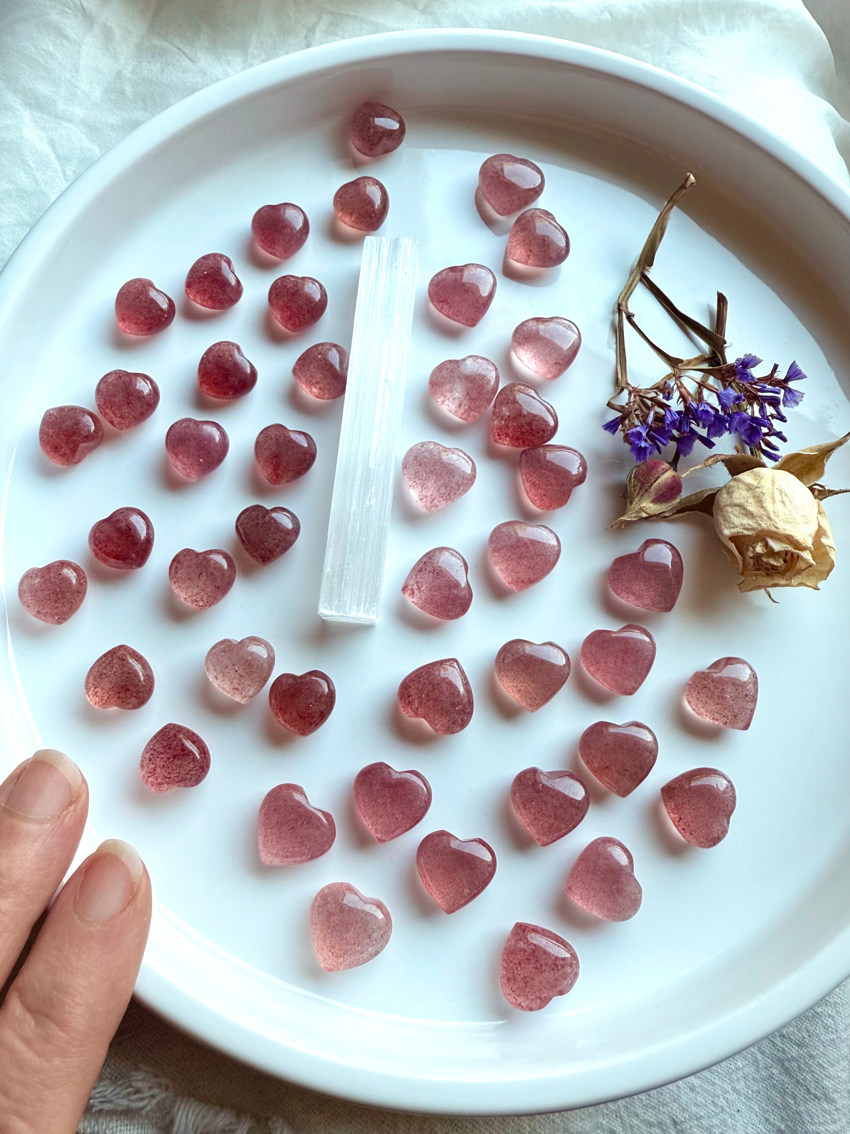 Wide angle of pink and red Strawberry Quartz mini carvings — crystal gift idea for love, joy, and heart chakra support.