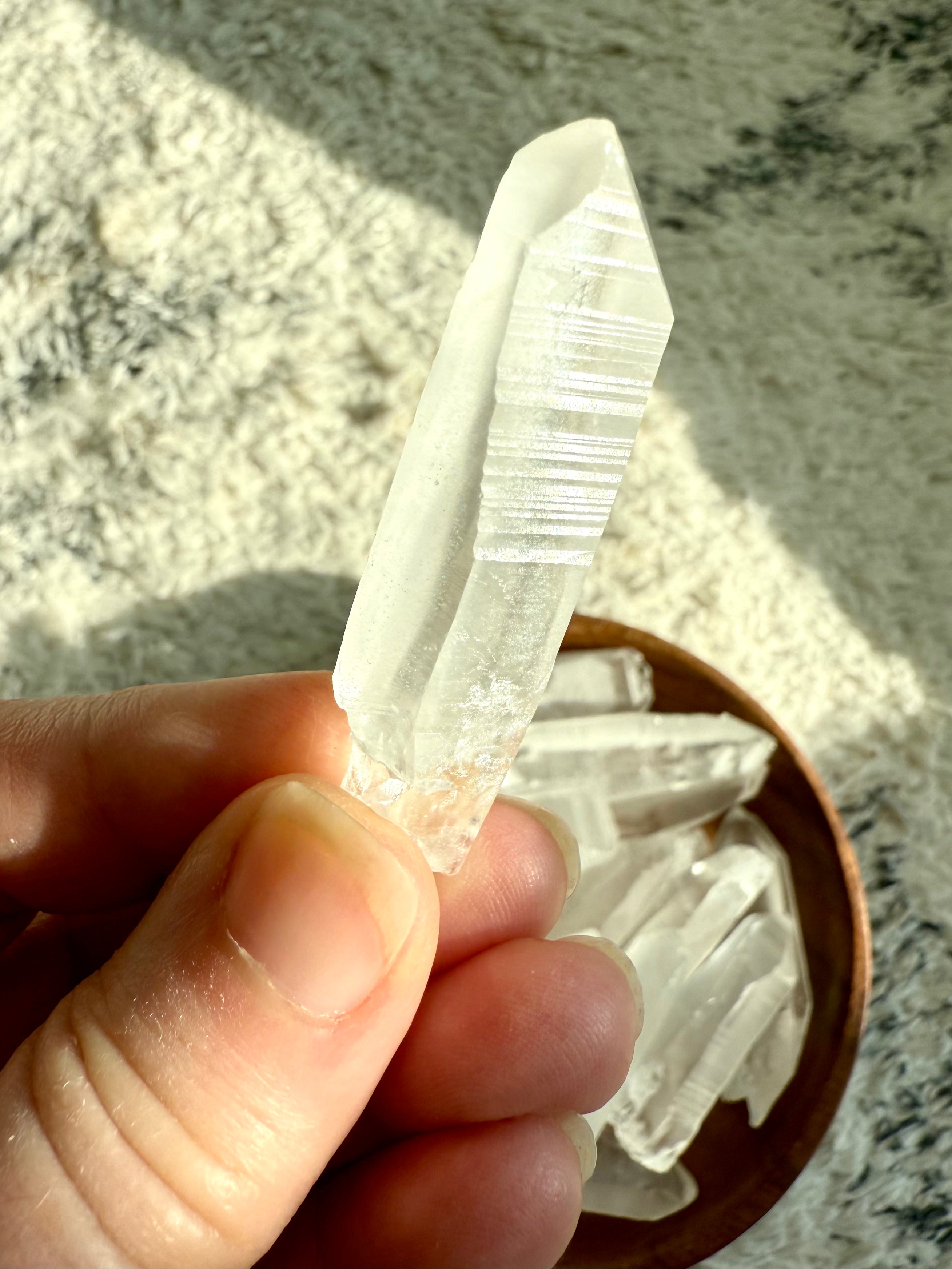 Close-up of Lemurian point with etched striations — spiritual tool for accessing higher realms and soul-level remembrance.