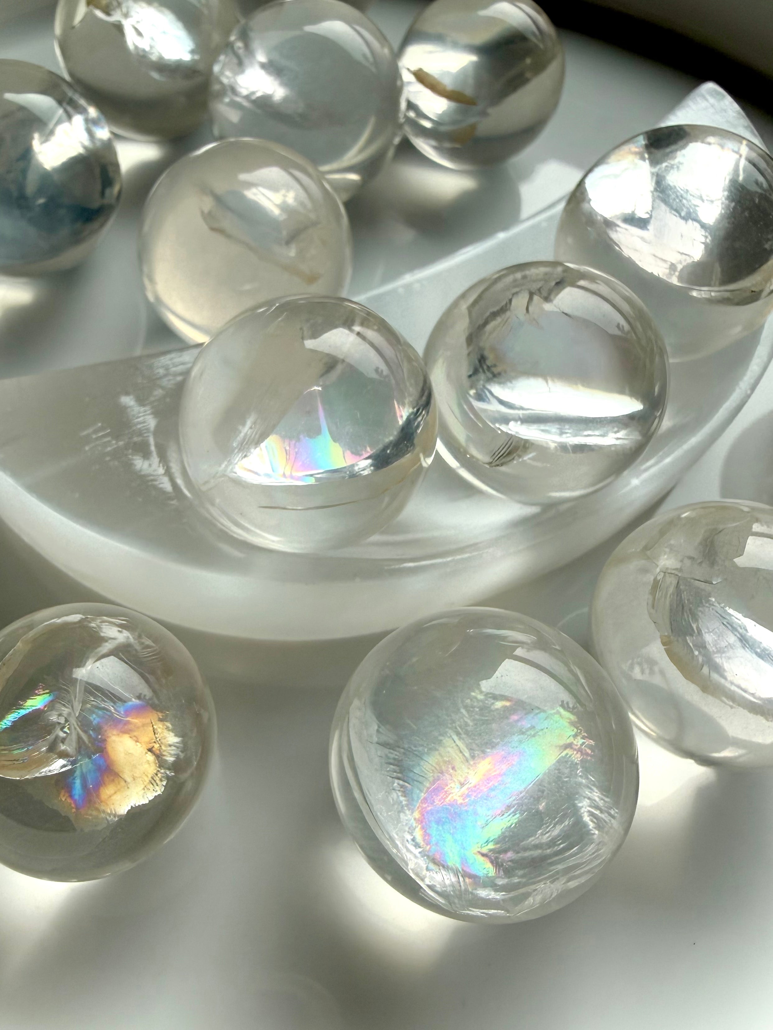 Rainbow girasol mini quartz spheres with luminous milky glow and silvery rainbows, high-vibration crystal balls for meditation and sacred space decor