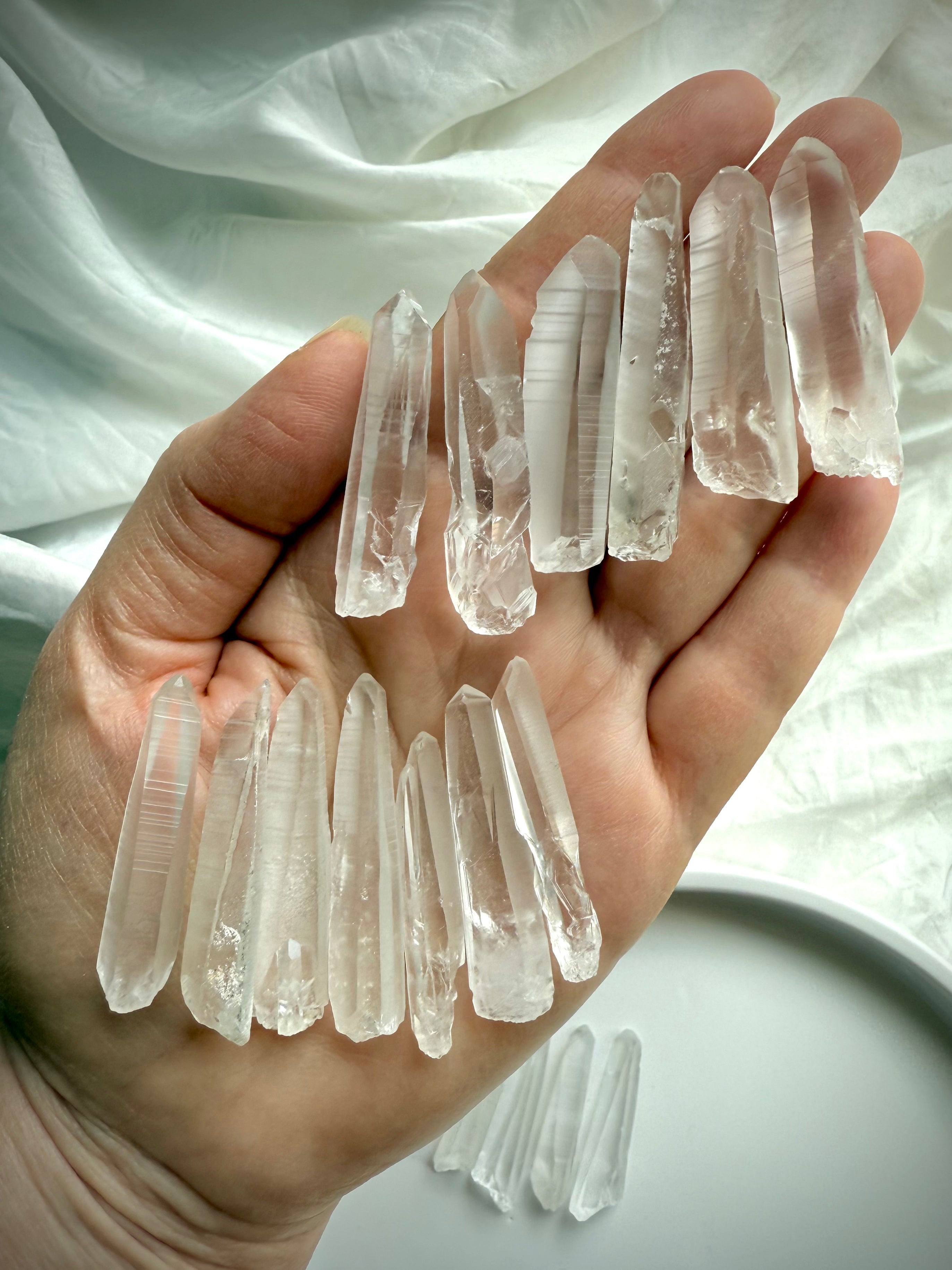 Lemurian Seed Quartz Points shown in hand to display size, striations & light-encoded texture — used for clarity, intuition & divine connection.