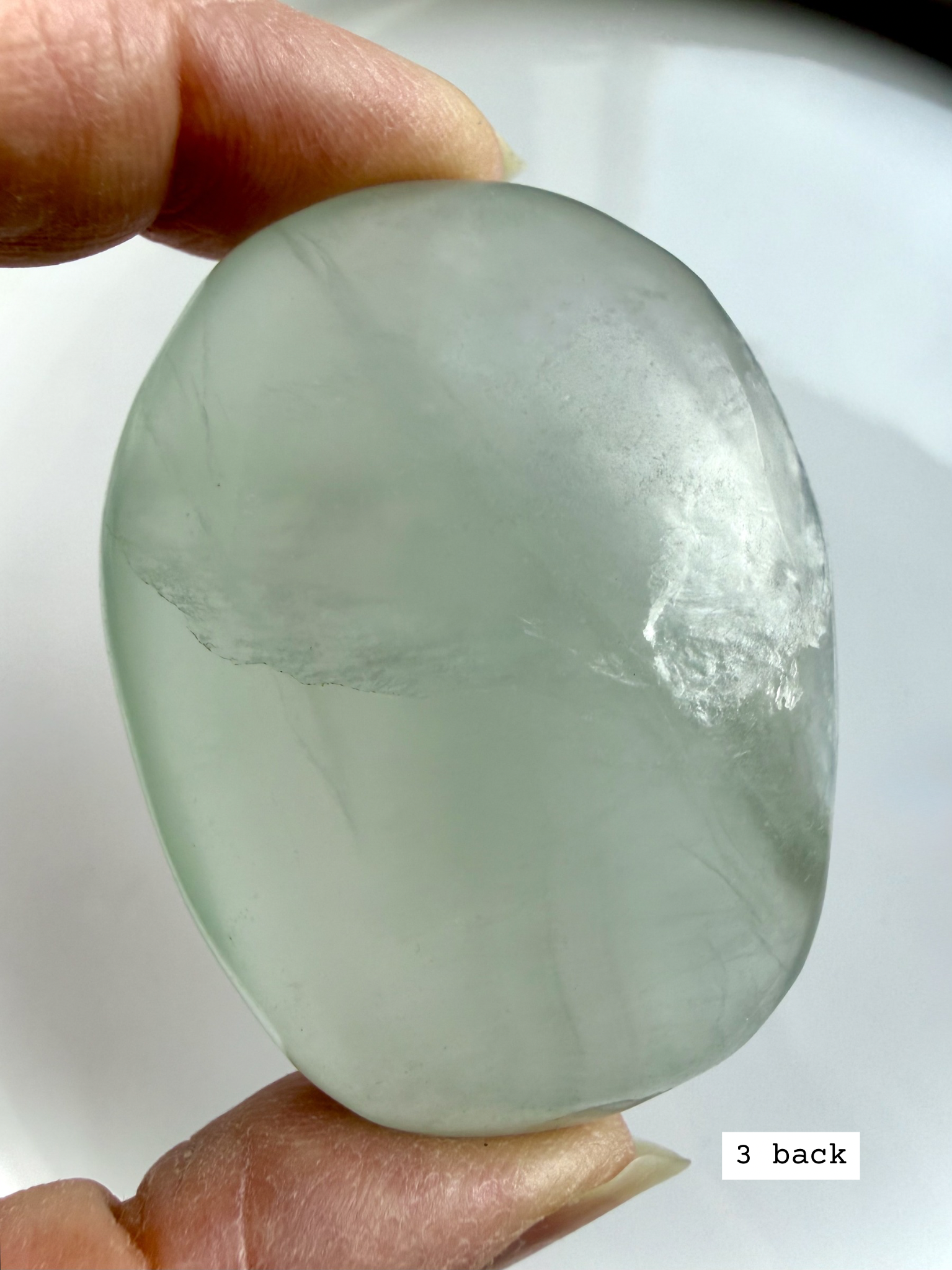 yttrium fluorite palm stone #3 back view showing natural lines and soft color transitions
