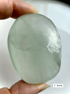 yttrium fluorite palm stone #3 back view showing natural lines and soft color transitions